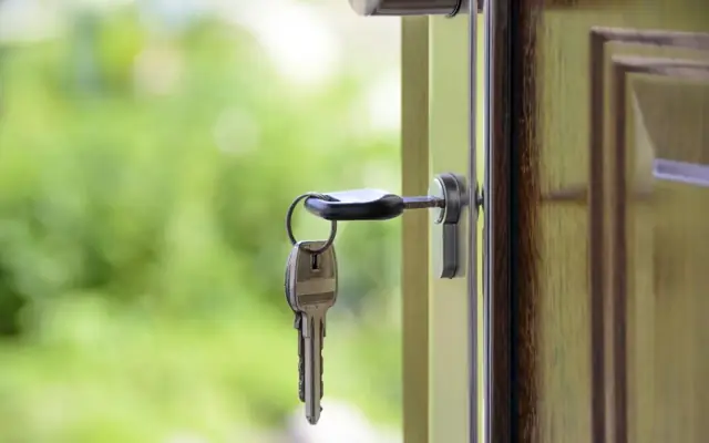 House key hanging in a front door lock